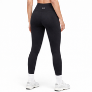 A fit girl wearing black leggings and white shoes